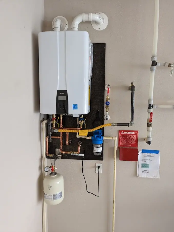 Professional plumber installing copper piping in a Weaverville home